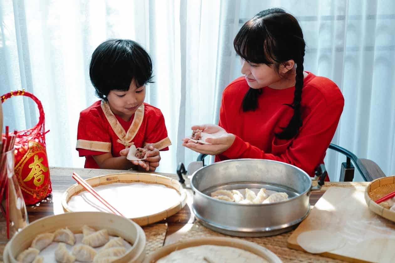 A parent teaching a child food preparation for home economics in homeschooling